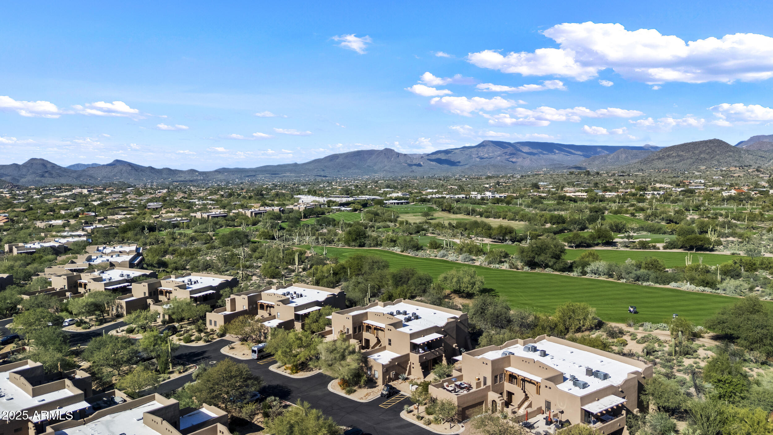 36601 North Mule Train Road, Unit D18 Carefree, AZ 85377 - Photo 43 of 57 an aerial view of a city with lots of residential buildings and mountain view in back