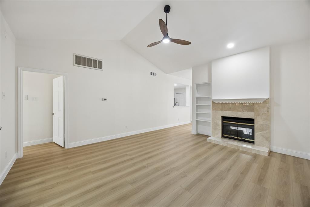 12660 Hillcrest Road, Unit 7205 Dallas, TX 75230 - Photo 6 of 25 Spacious living area featuring a vaulted ceiling, wood-finish flooring, and a ceiling fan
