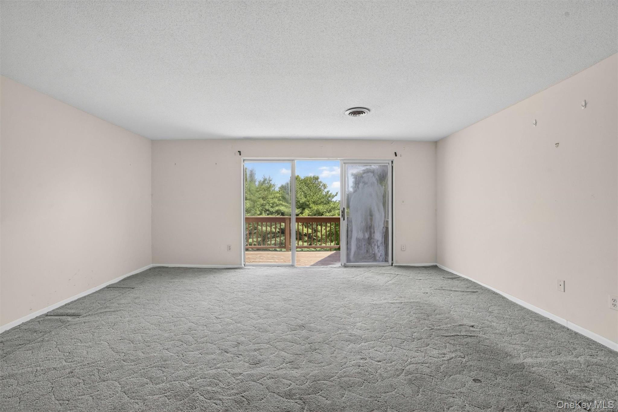 116 Fields Lane Peekskill, NY 10566 - Photo 12 of 40 an empty room with floor to ceiling window and an outdoor view