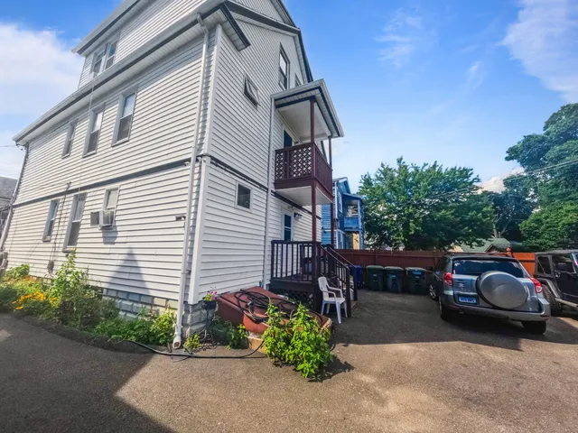 a view of a car park in front of a house