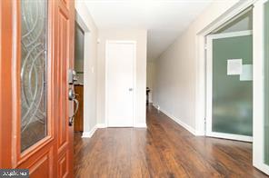 8515 Allentown Road Fort Washington, MD 20744 - Photo 2 of 8 a view of a hallway with wooden floor and a bathroom