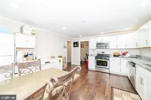 a large white kitchen with stainless steel appliances