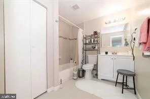 a bathroom with a toilet sink shower and mirror