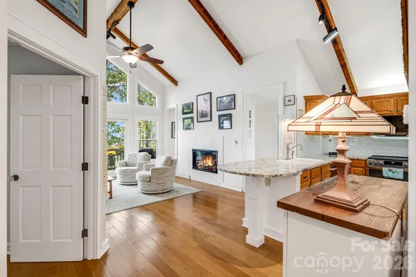 a living room with fireplace furniture and a wooden floor