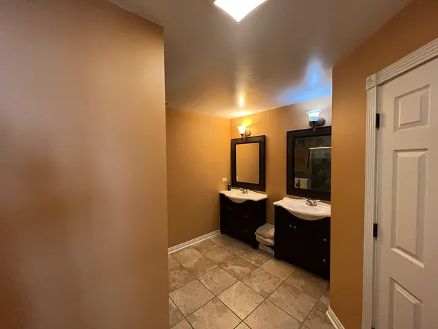a view of a hallway with wooden shelves