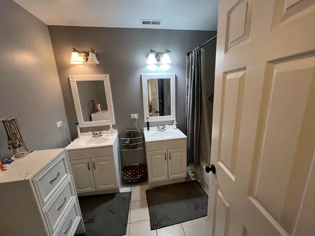 a bedroom with a bed and a view of kitchen
