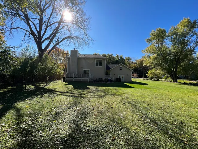 a front view of a house with yard and parking