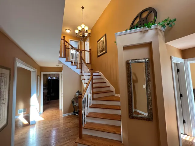 a view of entryway and hall with wooden floor