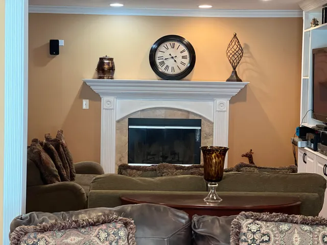 a living room with furniture a fireplace and a flat screen tv
