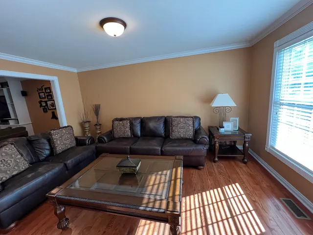 a bedroom with bed and a chandelier