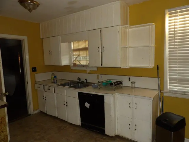 a bathroom with a granite countertop sink a mirror and a