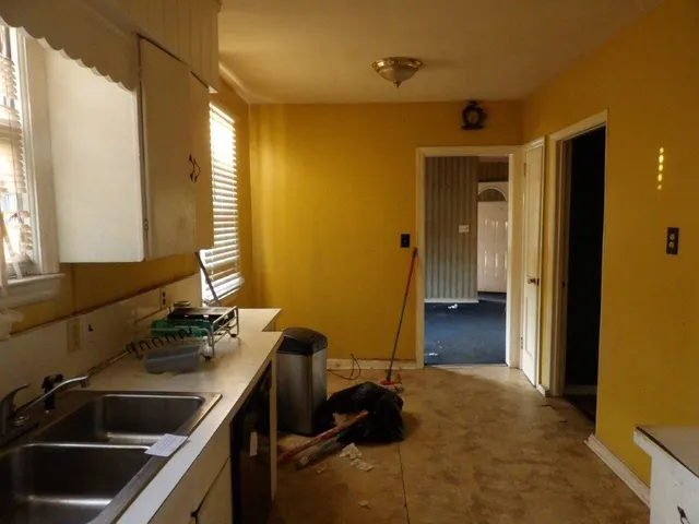 a kitchen with a sink and a stove top oven