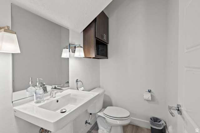 1122 South 1790th Street West, Unit 2 St. George, UT 84770 - Photo 11 of 37 Contemporary bathroom featuring a wall-mounted rectangular sink, chrome fixtures, and wood-finish flooring
