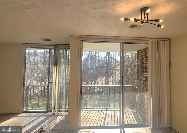 a view of a room with a glass door