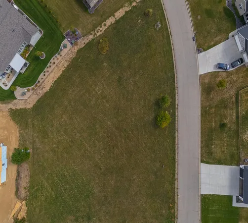 an aerial view of a house with a garden and swimming pool