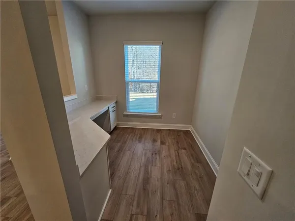 a view of a hallway in a house with wooden floor