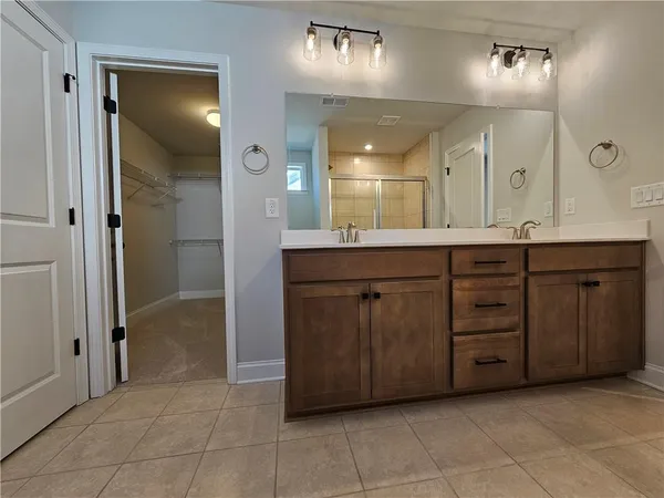 a spacious bathroom with a sink and a mirror