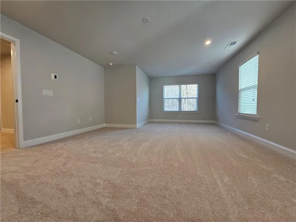 a view of an empty room with windows