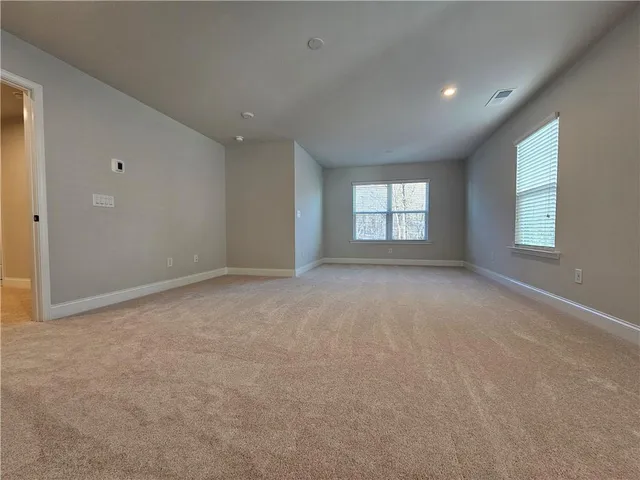 a view of an empty room with windows