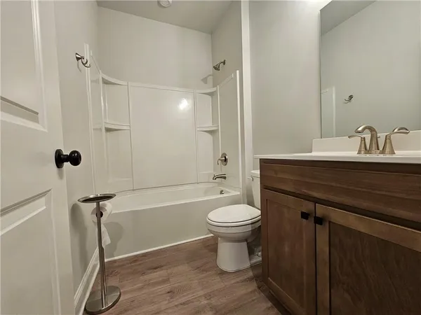 a large kitchen with stainless steel appliances a refrigerator and a stove top oven