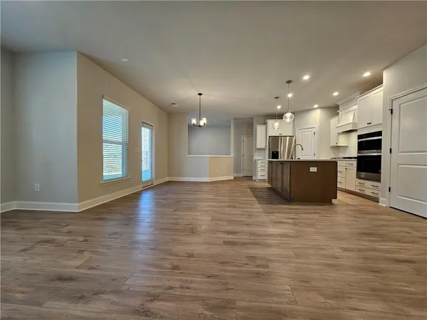 a view of a big room with kitchen and a window
