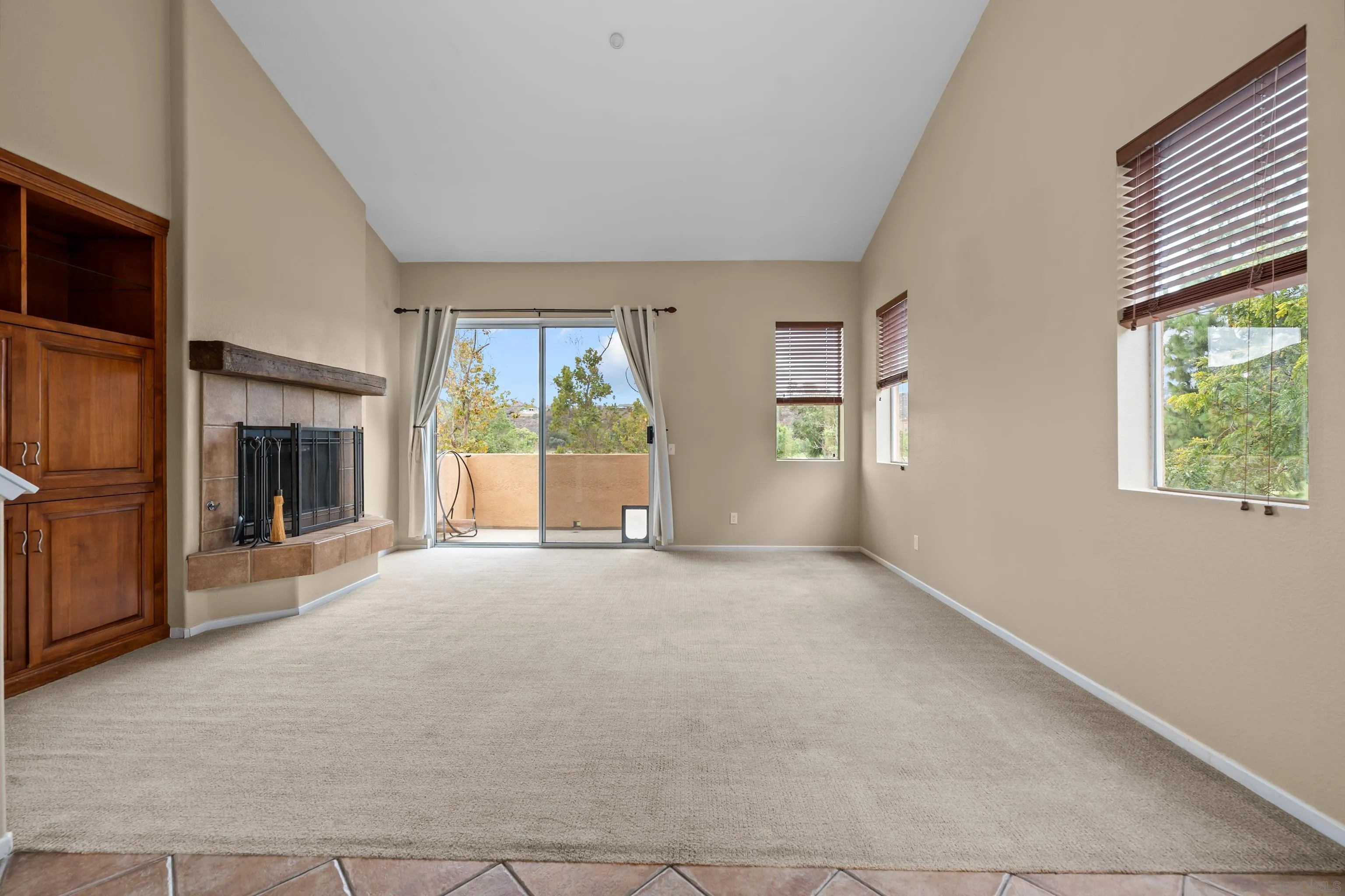 an empty room with windows fire place and windows