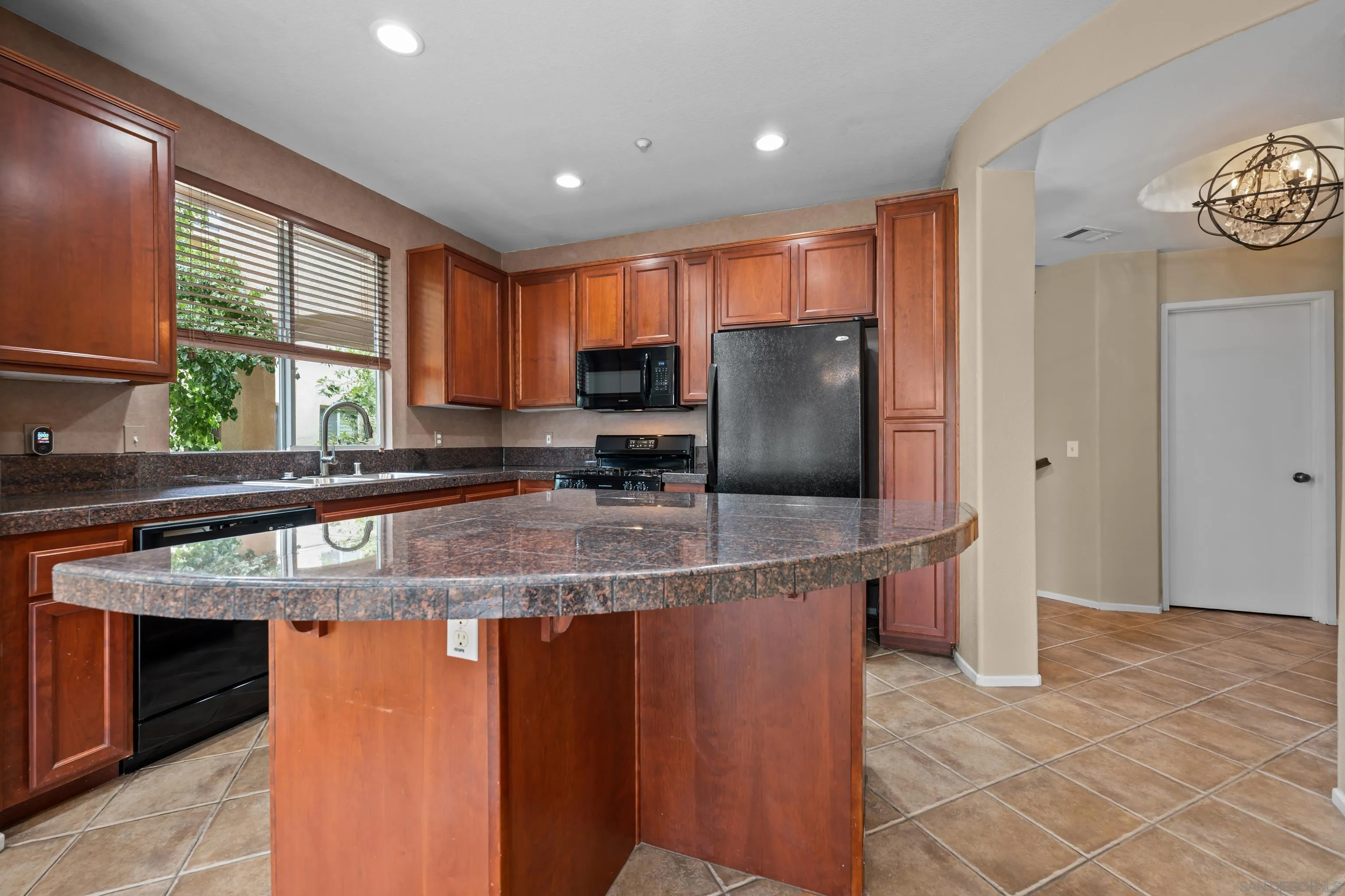3267 Dehesa Road, Unit 69 El Cajon, CA 92019 - Photo 12 of 34 a kitchen with stainless steel appliances granite countertop a sink and a refrigerator