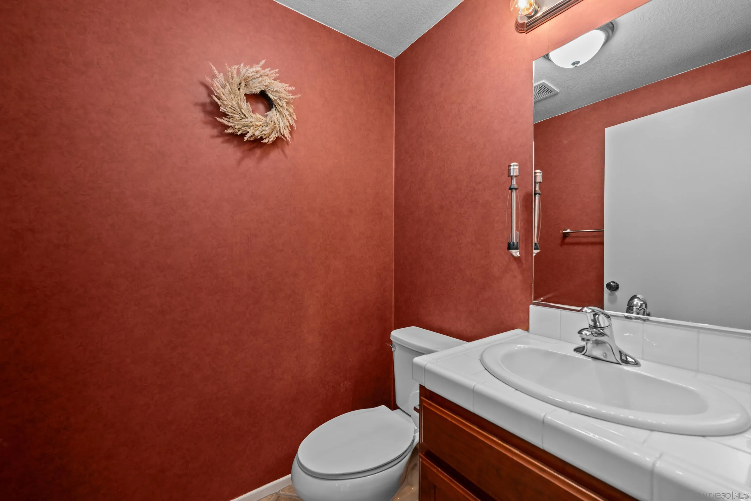 3267 Dehesa Road, Unit 69 El Cajon, CA 92019 - Photo 13 of 34 a bathroom with a sink a toilet and mirror