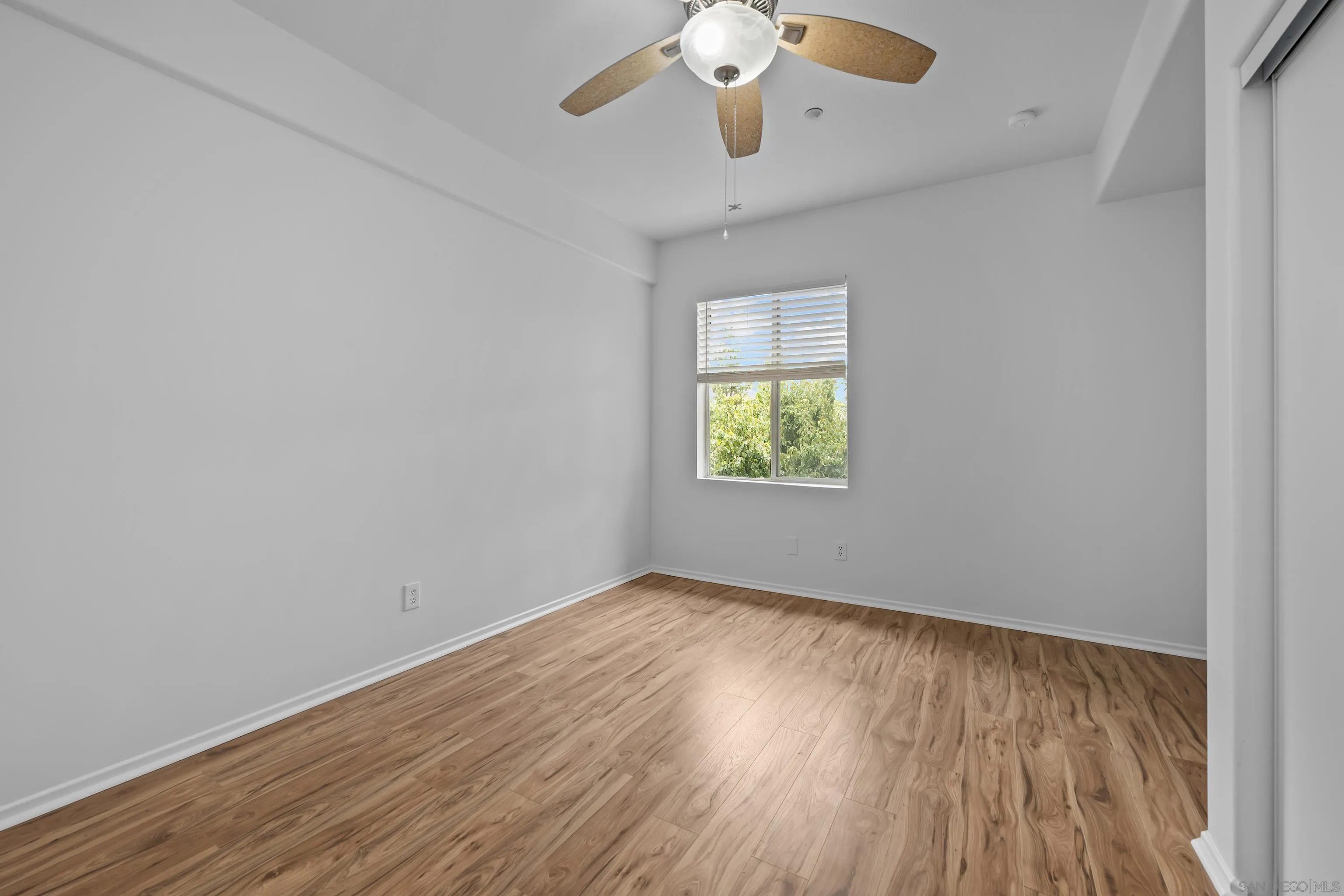 3267 Dehesa Road, Unit 69 El Cajon, CA 92019 - Photo 24 of 34 an empty room with wooden floor and windows
