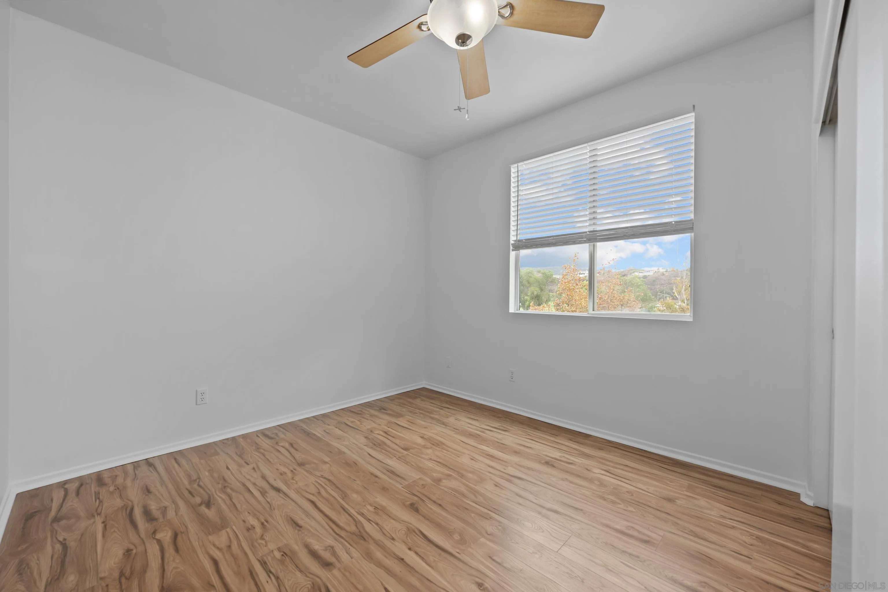 3267 Dehesa Road, Unit 69 El Cajon, CA 92019 - Photo 26 of 34 a view of an empty room with wooden floor and a window