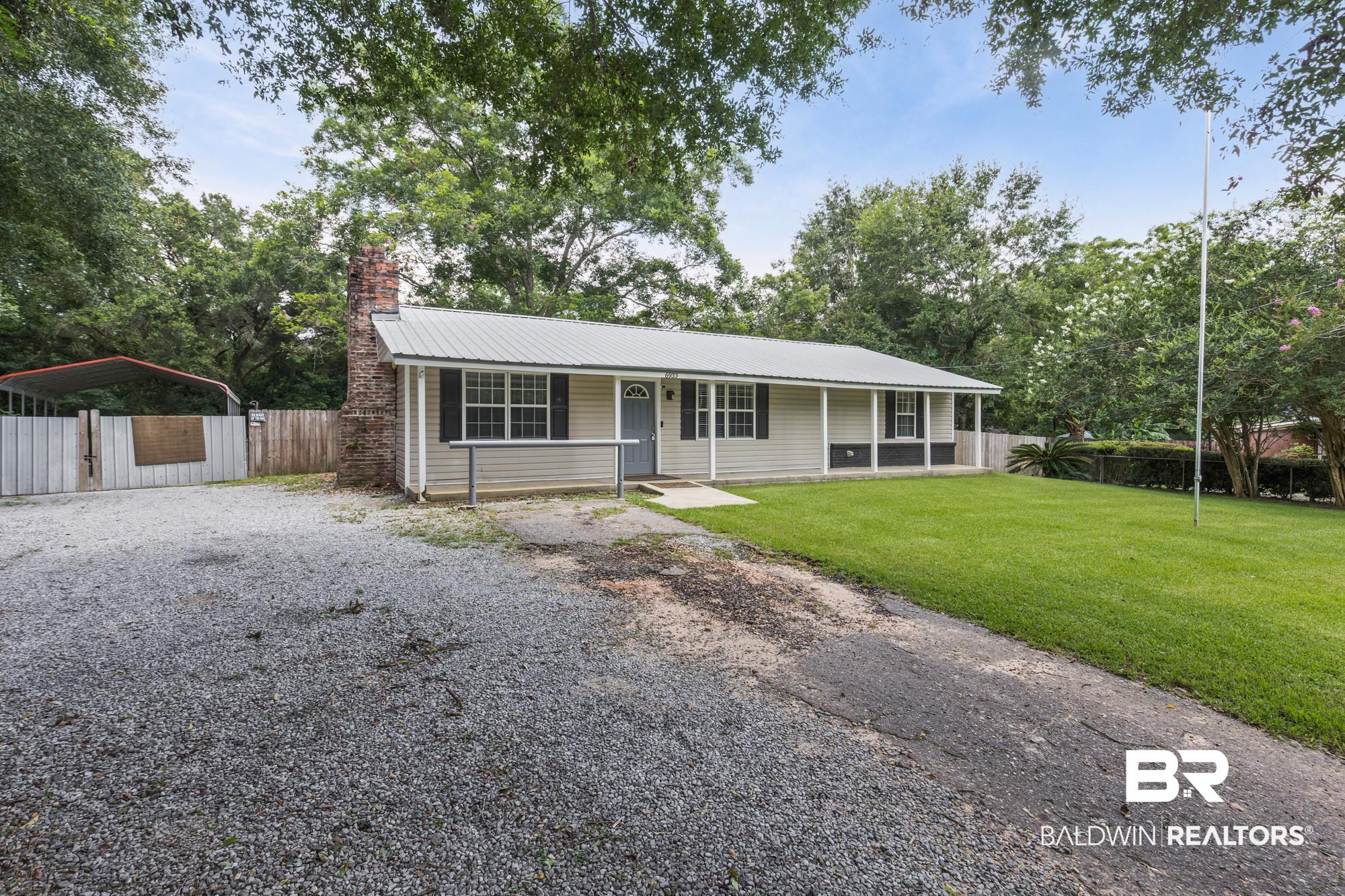 6933 Burbank Court Mobile, AL 36619 - Photo 24 of 25 Ranch-style residence featuring light-toned siding, a metal roof, and a brick chimney