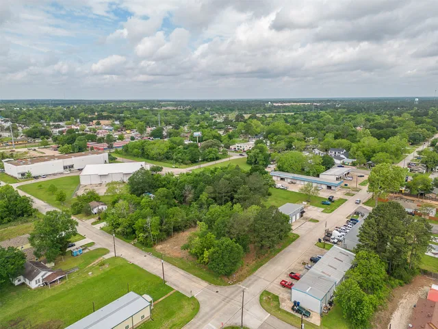 an aerial view of a city with lots of residential buildings green landscape and city view