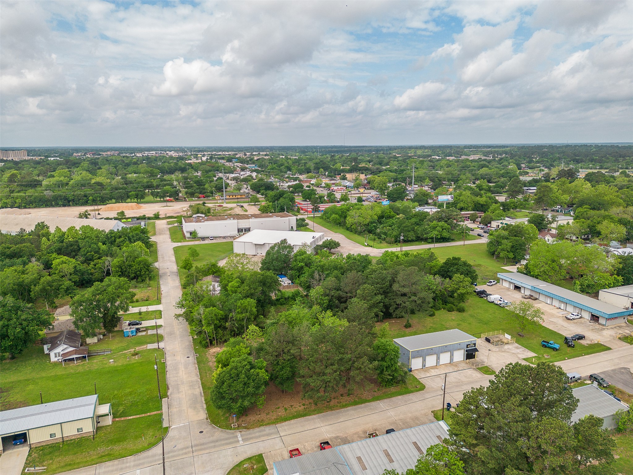 Tbd Mechanic Street Tomball, TX 77375 - Photo 14 of 24 an aerial view of a city with lots of residential buildings green landscape and mountain view in back