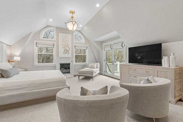 a living room with fireplace furniture and a flat screen tv