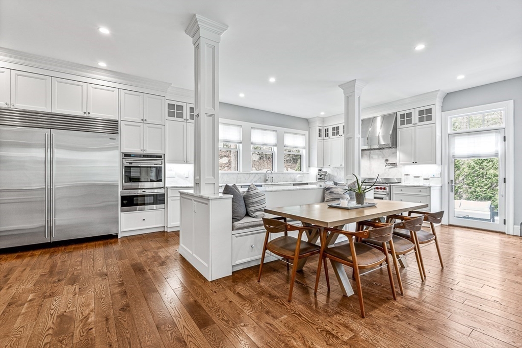 168 Beaver Road Weston, MA 02493 - Photo 8 of 27 a kitchen with stainless steel appliances a dining table chairs stove refrigerator and cabinets