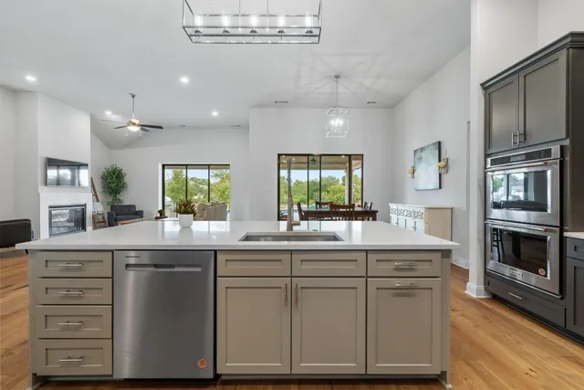 a kitchen with cabinets and chairs