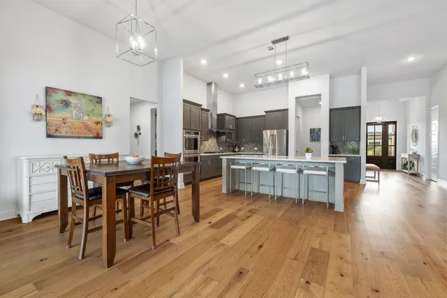 a large kitchen with a table and chairs