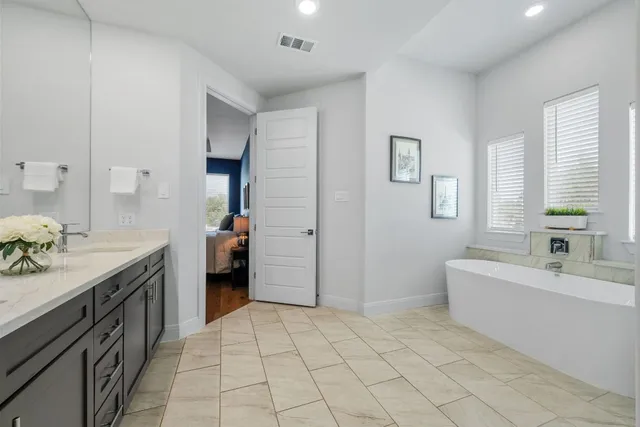a spacious bathroom with a sink and a mirror