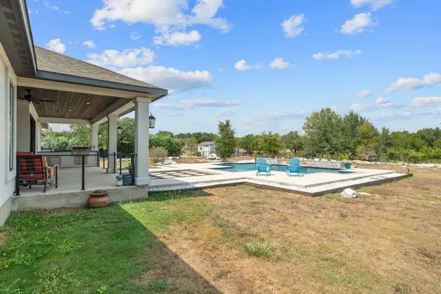 a view of a swimming pool with an outdoor seating