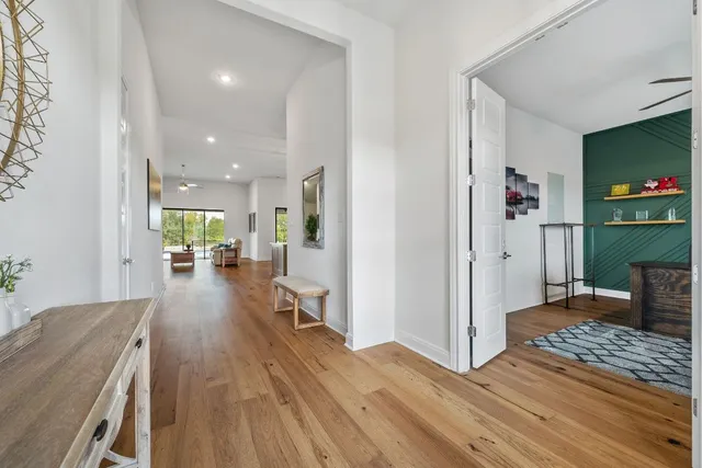 a living room with furniture and a wooden floor
