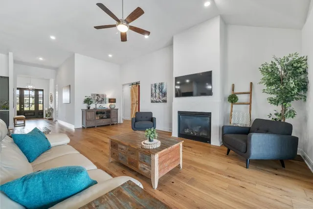 a living room with furniture a fireplace and a flat screen tv