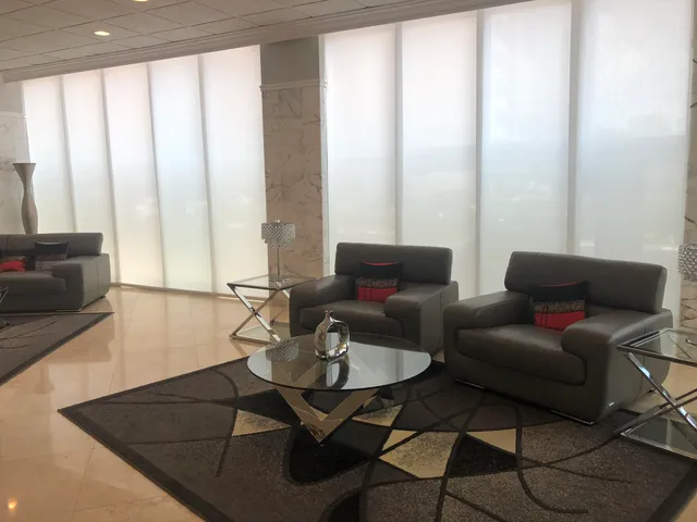 a living room with furniture and a large window