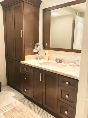 a bathroom with a sink vanity and a mirror
