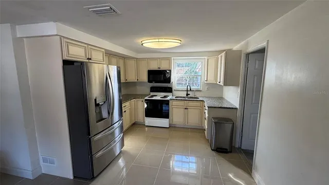 a kitchen with a refrigerator stove and microwave