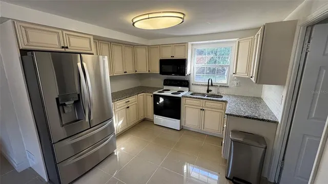 a kitchen with a refrigerator sink and stove