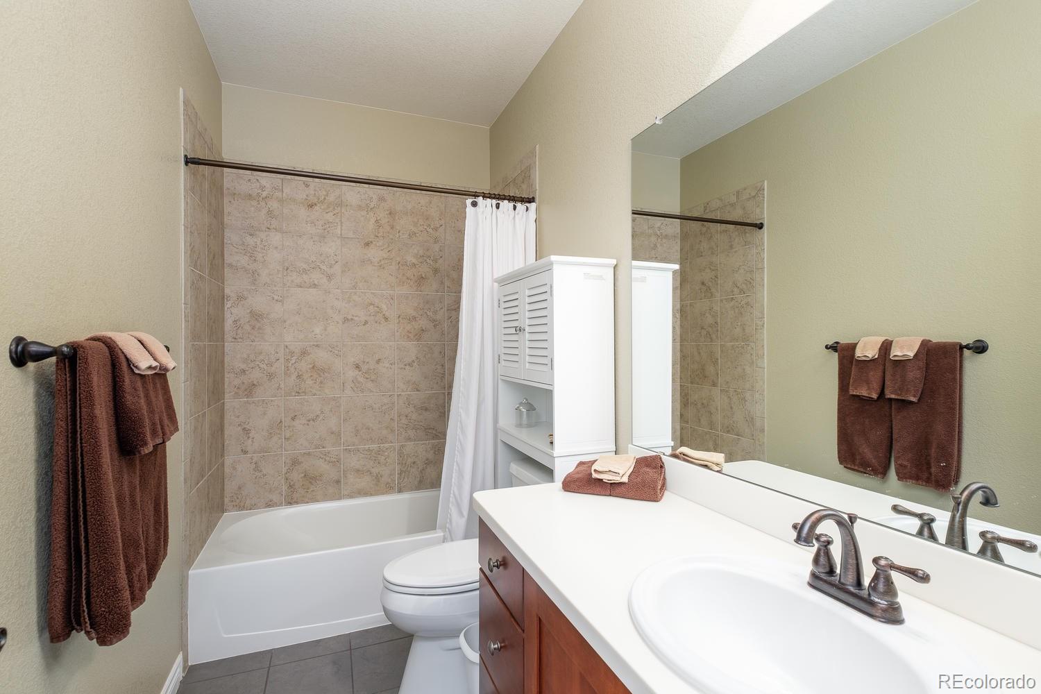 9233 Viaggio Way Highlands Ranch, CO 80126 - Photo 28 of 35 a bathroom with a sink toilet and shower