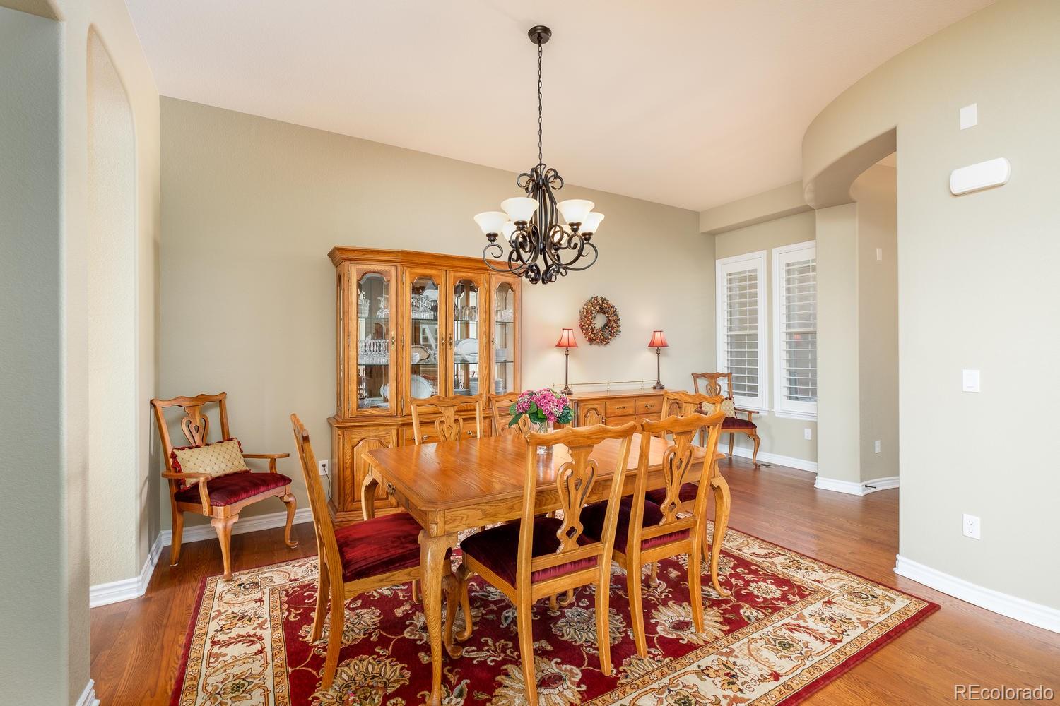 9233 Viaggio Way Highlands Ranch, CO 80126 - Photo 3 of 35 a view of a dining room with furniture and chandelier