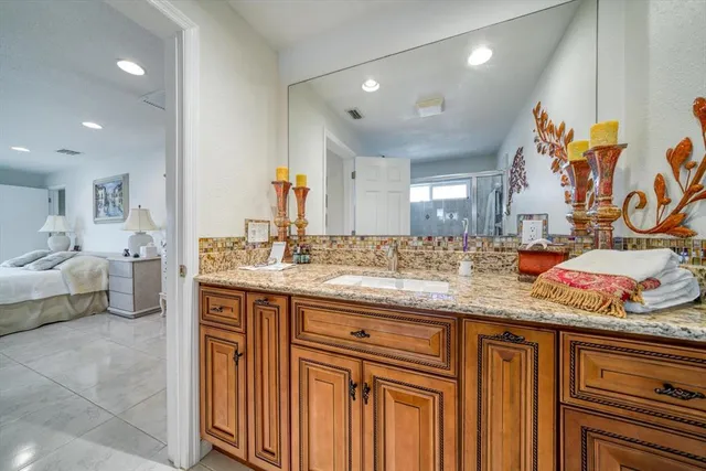a view of bathroom with a sink and a mirror