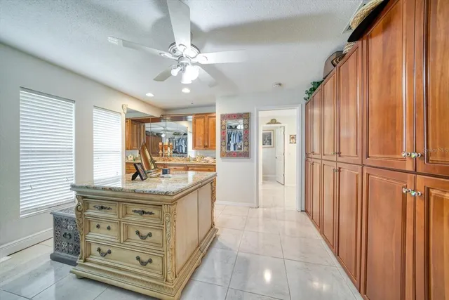 a kitchen with stainless steel appliances granite countertop a sink and a refrigerator