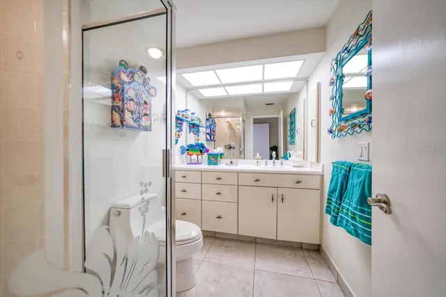 a bathroom with a painting on the wall and a shower curtain